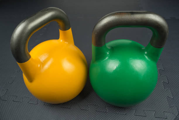 istock Yellow and green competition kettlebells on a gym floor 862250834