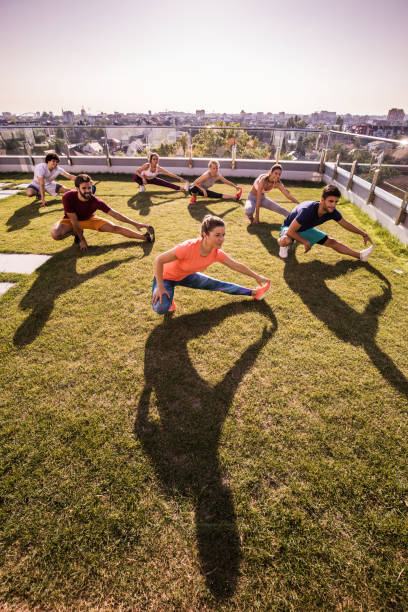 istock Above view of young athletes doing stretching exercises on a penthouse terrace. 862250944