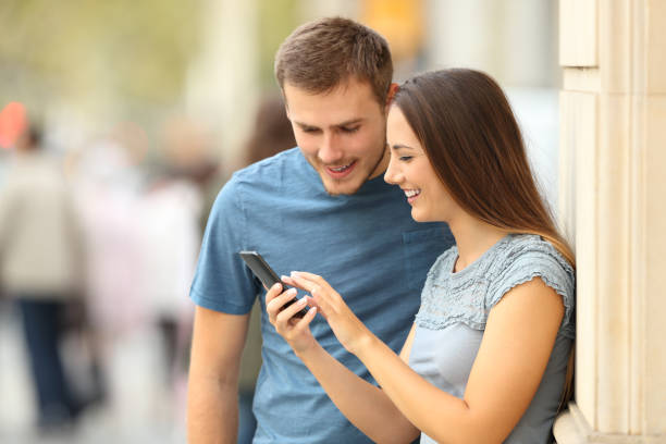 istock Couple checking content in a smart phone on the street 862251252