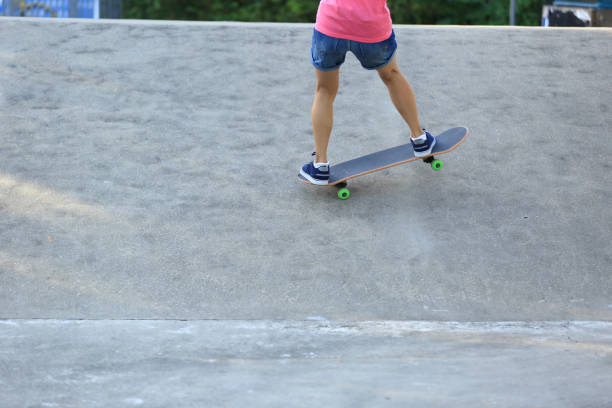 istock Skateboarder legs riding skateboard at skatepark 862252044