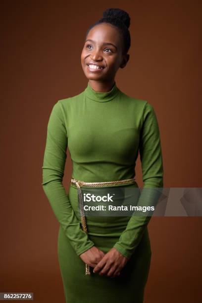 Studio Shot Of Young Beautiful African Zulu Businesswoman Wearing Green Outfit Against Colored Background Stock Photo - Download Image Now