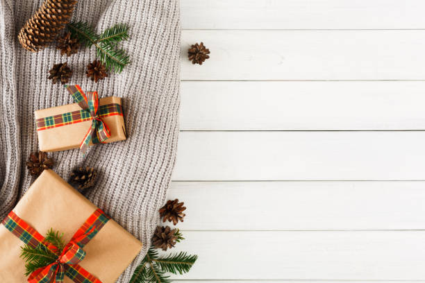 istock Christmas creative boxes, knitted scarf on white wood background 862257364