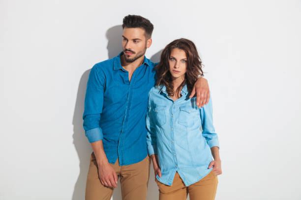 istock man looks to side while holding woman next to him 862257904