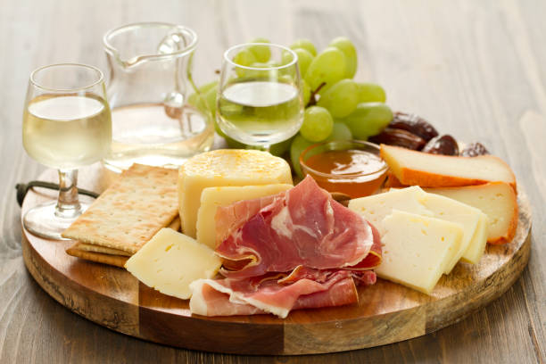 istock prosciutto with cheese and white wine in wooden board 862258498
