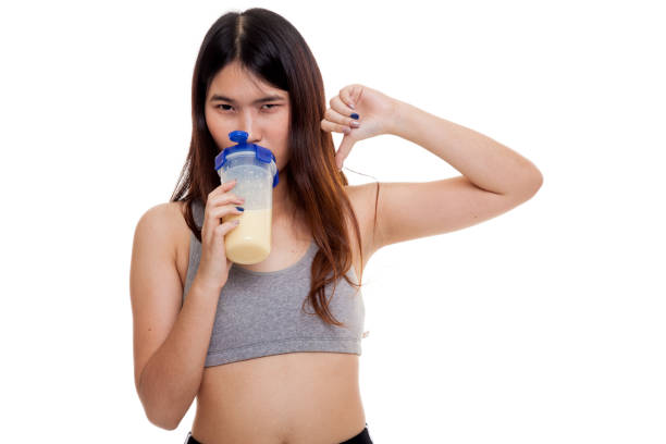 istock Beautiful Asian healthy girl thumbs down hate whey protein. 862258514