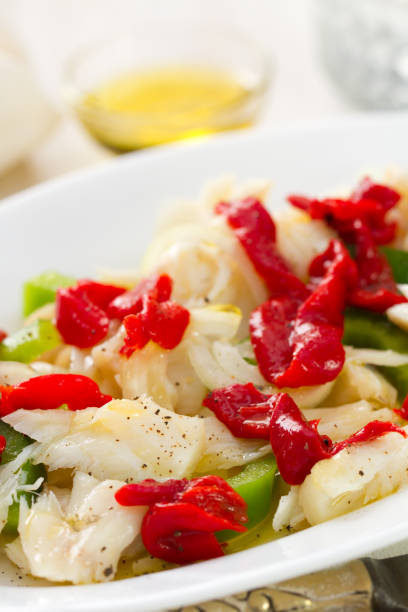 istock fish salad with pepper on white dish on white wooden background 862260832