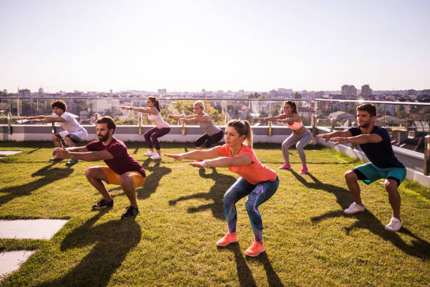 istock Young athletes doing squats during a sports training on a penthouse balcony. 862261150