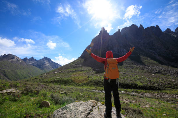 istock cheering successful woman hiker on mountain top 862261282