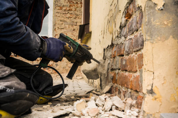 worker with electrical hammer cleaning red brick wall outdoor - drill red work tool power imagens e fotografias de stock