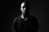 istock Studio shot of young African man wearing black shirt in black and white 862263568