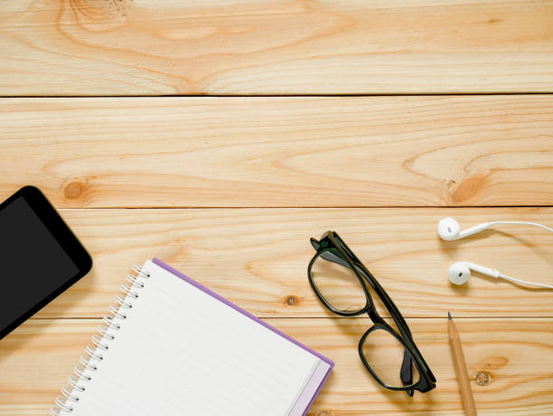istock Notebook with pencil, mobile phone, glasses and earphones 862270392