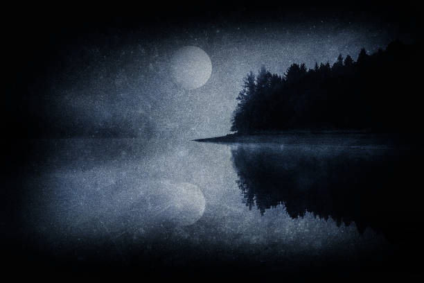 dark scary landscape with a lake a forest and full moon