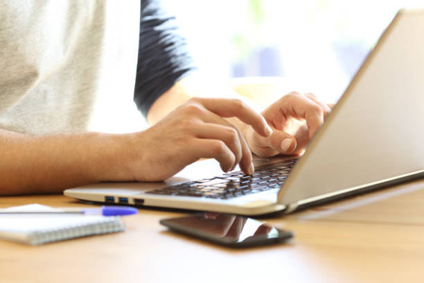 istock Man hands writing on a laptop at home 862273508