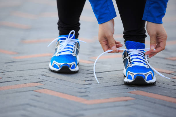 istock Young woman runner tying shoelace before run 862273966