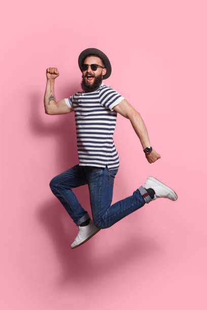 istock Stylish man jumping on pink 862274168