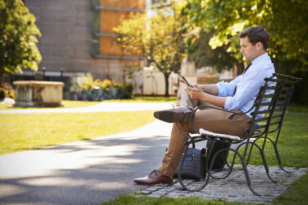 istock Businessman Outdoors Using Digital Tablet On Lunch Break In Park 862274408