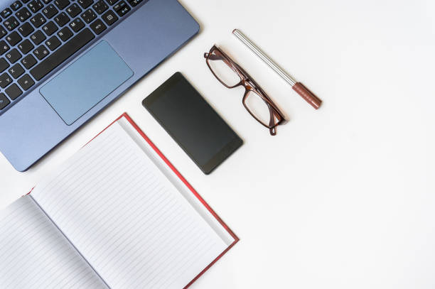 istock Workplace with laptop and smartphone on white wooden table 862274596