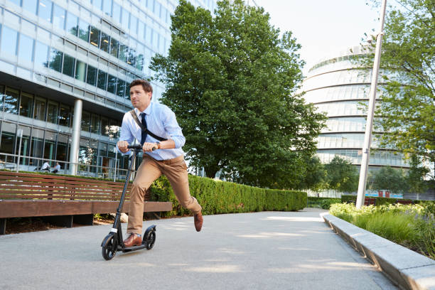 istock Young Businessman Commuting To Work Through City On Scooter 862277490