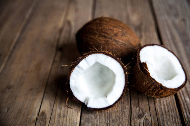 istock Ripe half cut coconut on  wooden background 862278174