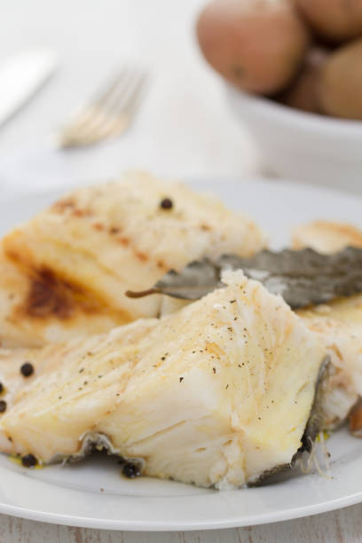istock boiled cod fish with black pepper on white plate and potato in bowl 862282836