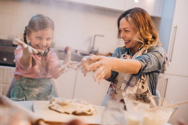 istock Carefree mother and daughter having fun with flour while making a cake. 862286076