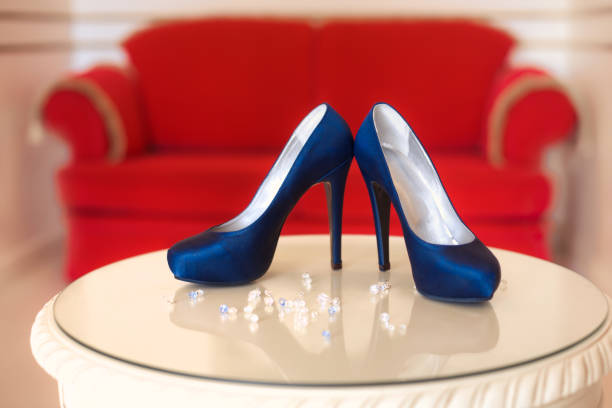 Designer blue high heels shoes in red interior