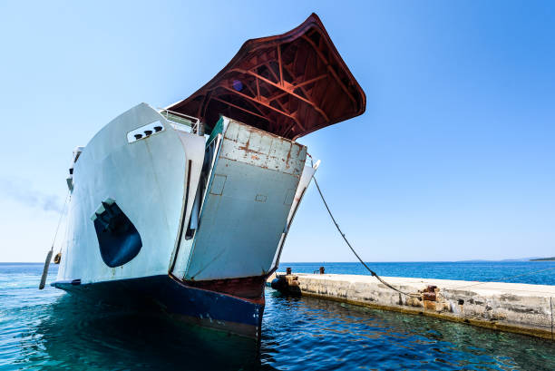 istock Front loading ferry boat moored with lifted bow at pier. 862289440