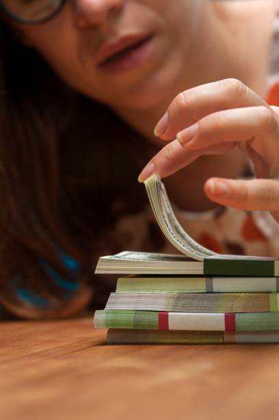 istock Young woman counting money heaps on the table 862296324