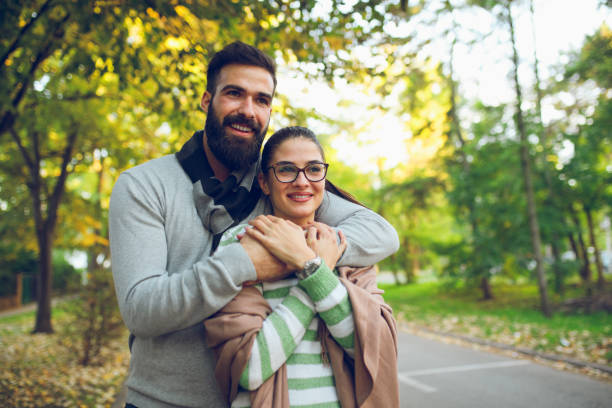 istock Young affectionate couple in an autumn park 862297428