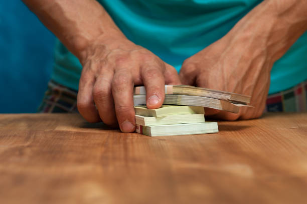 istock Man standing next to the table with currency heaps 862297478