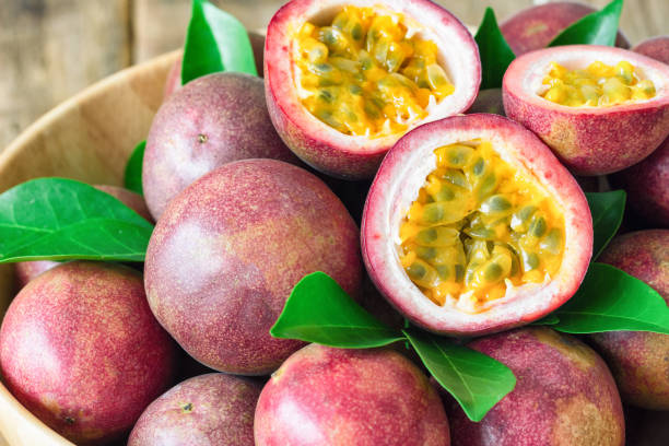 istock Close up fresh passion fruit in wood bowl on wood table in side view with copy space for background or wallpaper. Ripe passion fruit so delicious sweet and sour. Tropical fruit. Macro concept. 862297876