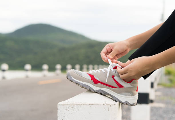 istock Woman tying shoelace his before starting running 862306684