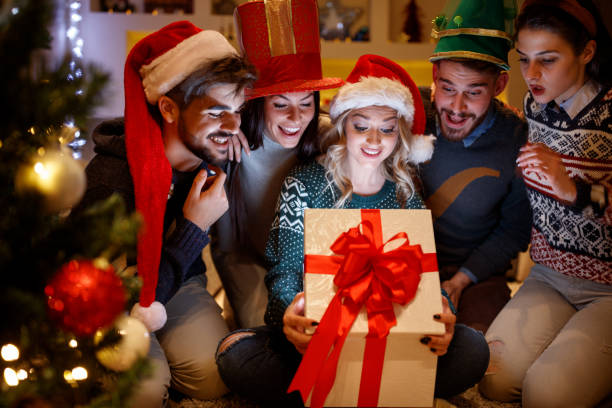 istock smiling friends opening magic Christmas gift 862307078