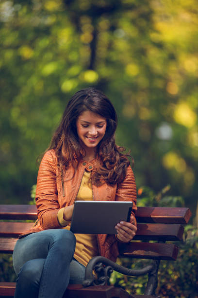 istock Young woman with tablet in the park 862309434