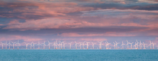 Wind Farm in motion at Sunset in the Solway Firth, United Kingdom stock photo