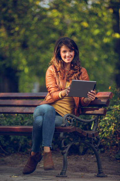 istock Young woman with tablet in the park 862309878