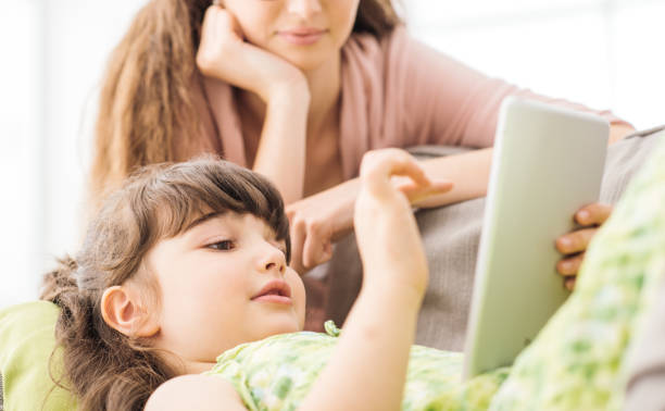 istock Mother and daughter using a tablet together 862310660