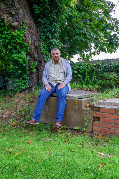 istock Senior man sitting in cemetery 862310832