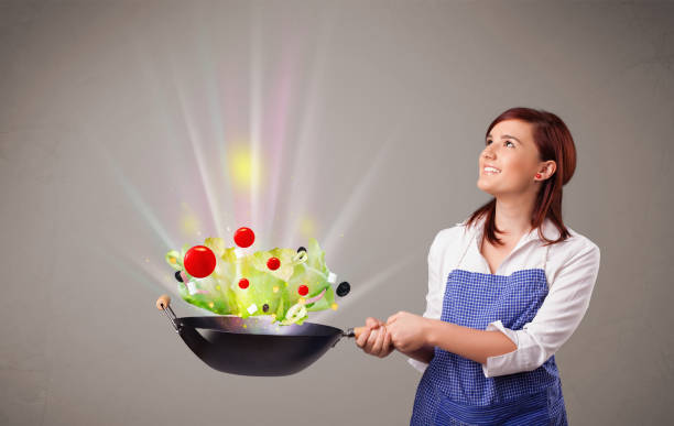 istock Young woman cooking fresh vegetables 862317894