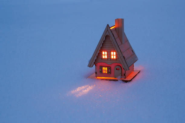 istock A house with light from a window in the snow 862318178
