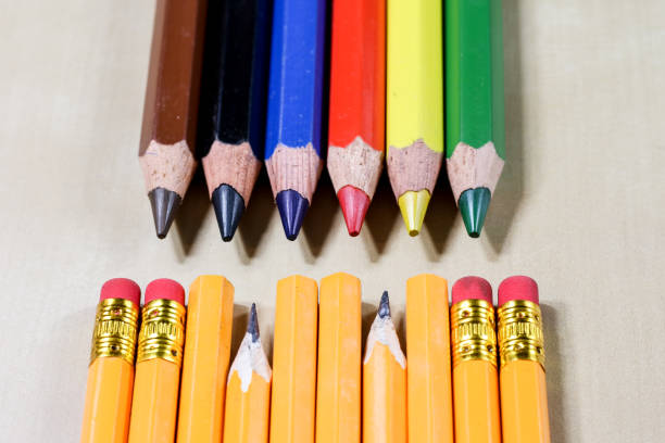 istock crayons and pencil sharpener on a wooden office table. Crayons with sharpening crayons and pencils on the table next to colored pencils. black background. 862320502