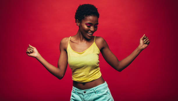 istock African woman dancing over red background 862321146