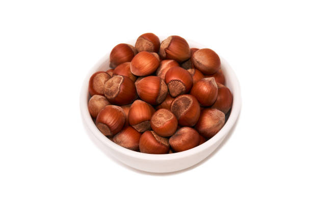 istock Nuts in a white bowl isolated on white background, top view 862322162