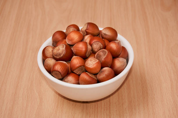 istock Nuts in a bowl on a wooden background, Brown nuts. Nuts. Top view. 862324300