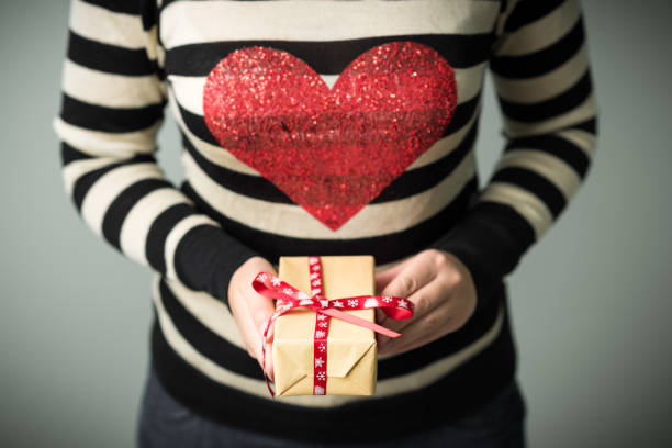 istock A girl holding a box with a Christmas present 862325044
