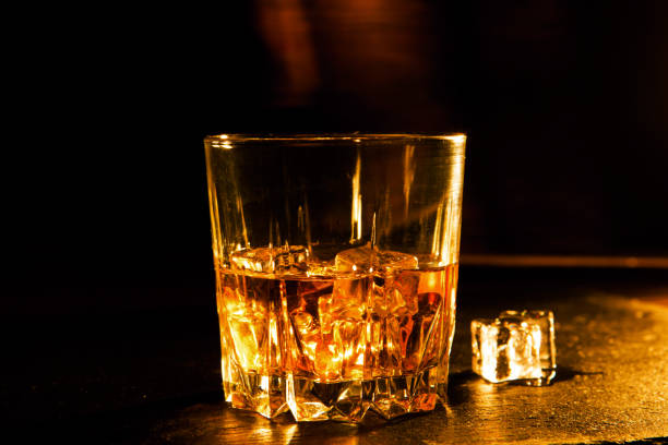 istock Whiskey drink on wooden table over dark background 862330676
