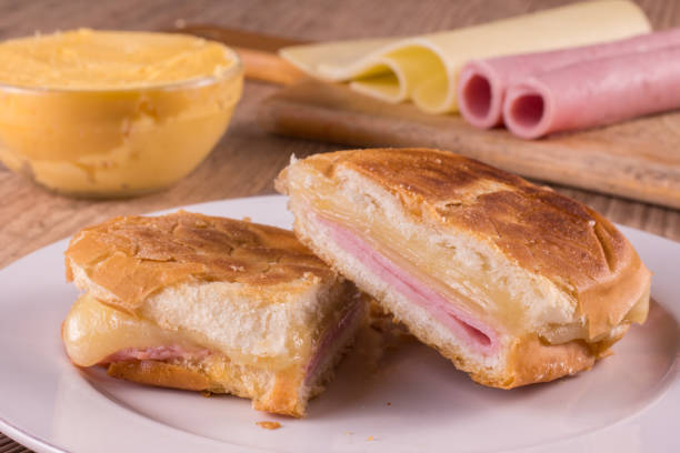 Hot Cheese Sandwich. Brazilian Mixed Hot Hot Cheese Sandwich. Brazilian Misto Quente over a wooden table ham and cheese sandwich stock pictures, royalty-free photos & images