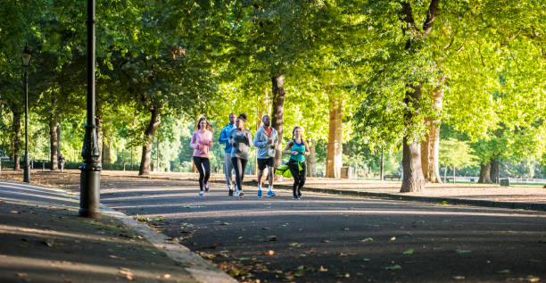 istock Happy young friends running together 862334868