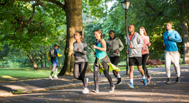istock Happy young friends running together 862334968