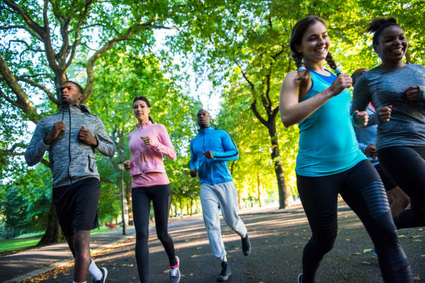 istock Happy young friends running together 862334990